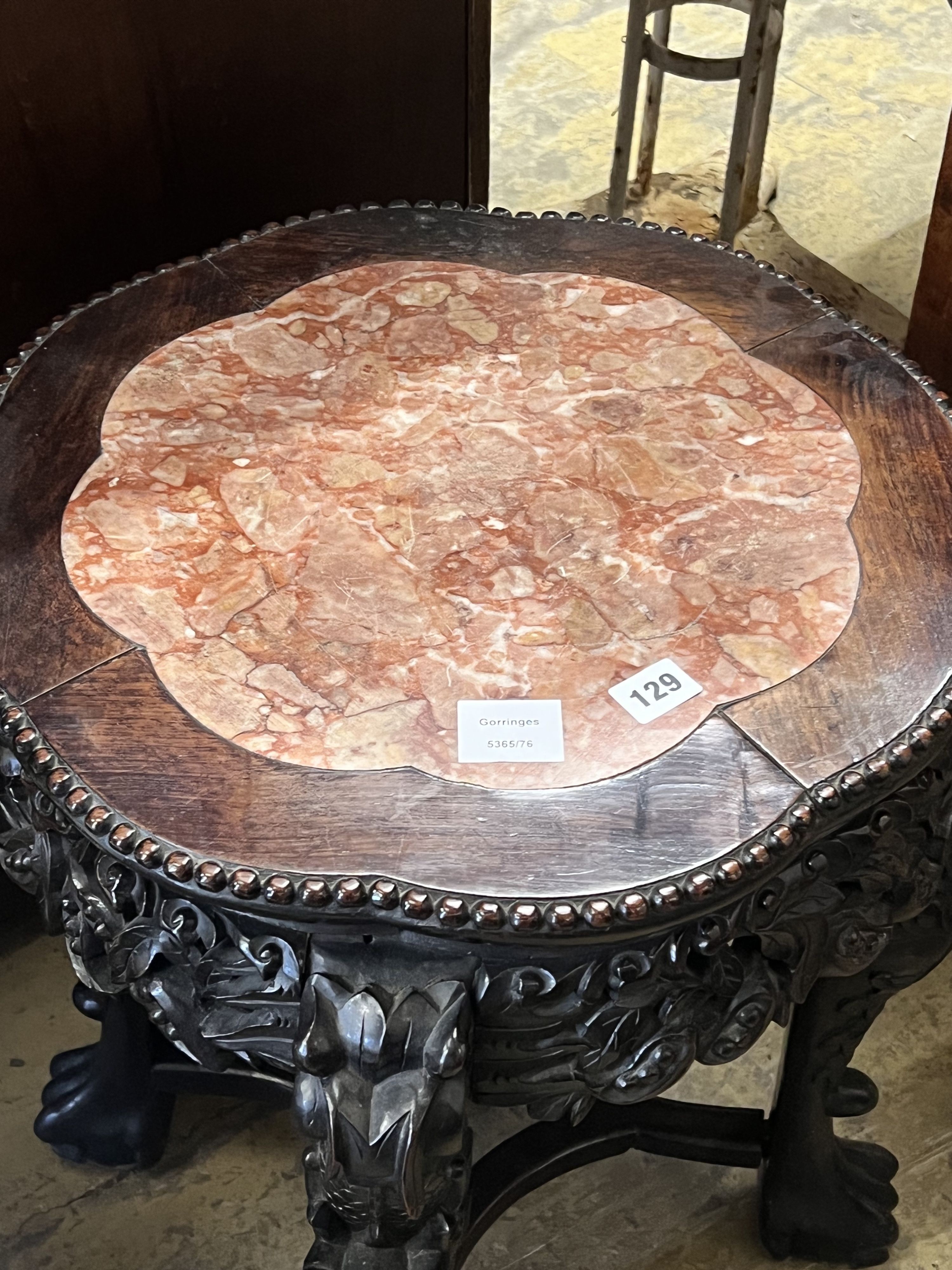 A Chinese carved hongmu circular marble topped jardiniere stand, diameter 46cm height 58cm
